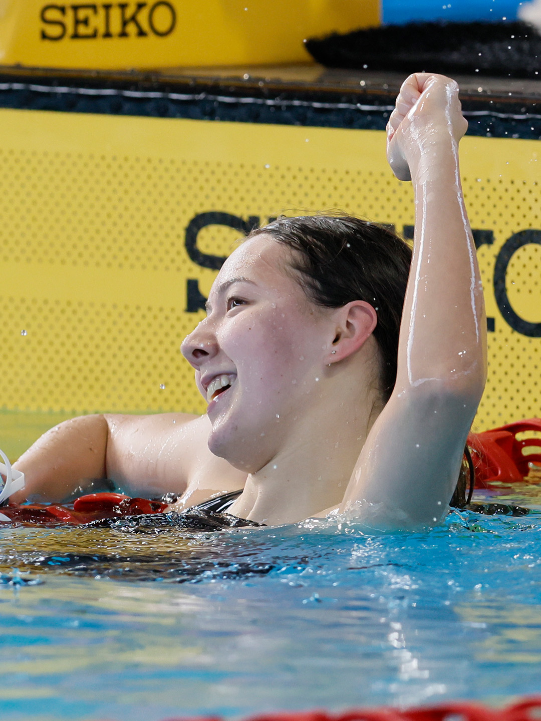 Eliza Ai Shen Tan celebrates her national record swim in the Women's 100m Freestyle