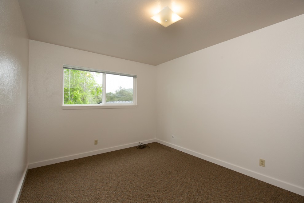 Unfurnished bedroom with large window