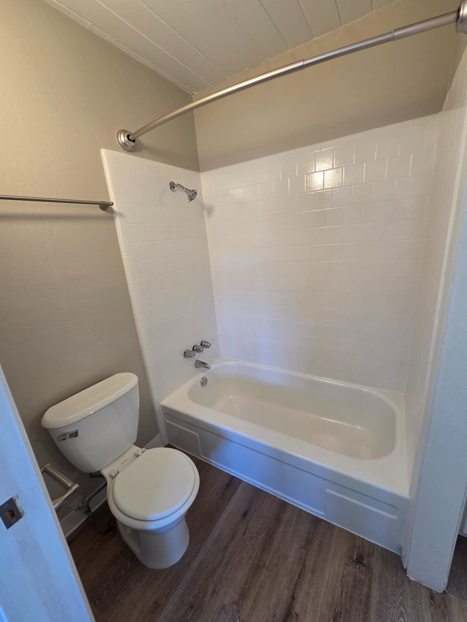 bathroom with shower and tub