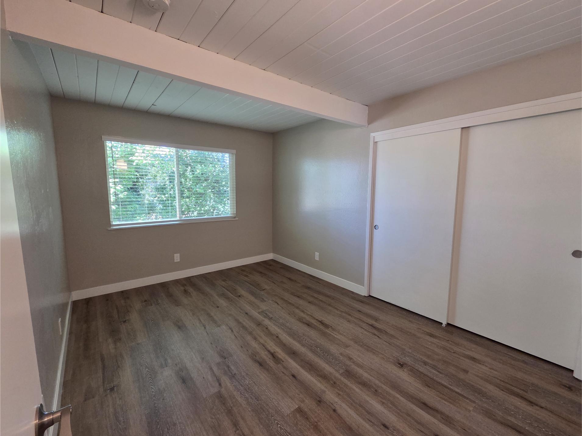 large bedroom with window and closet