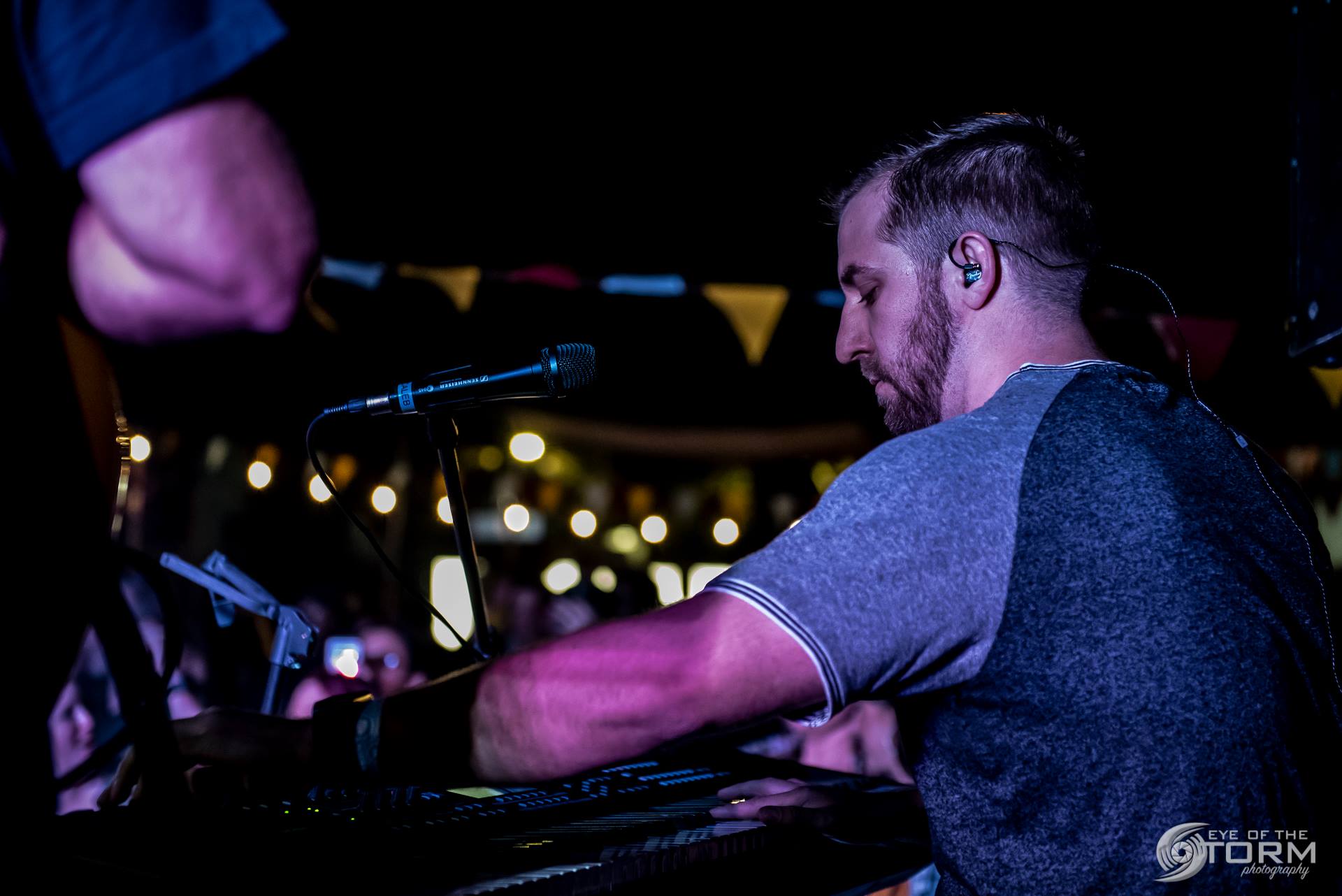 Caleb Stark performing live with a rock band.
