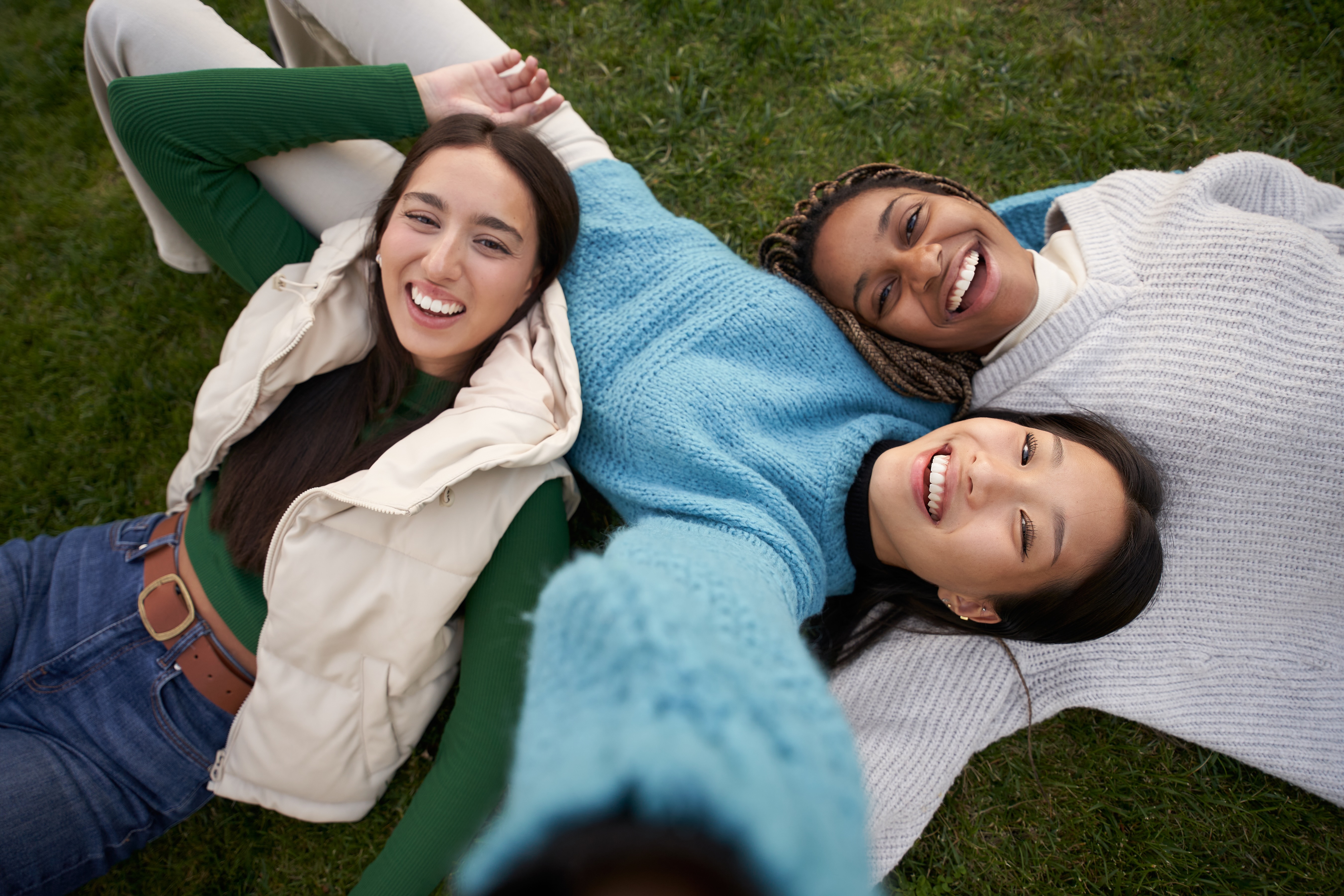 Friends laying in grass stock photo