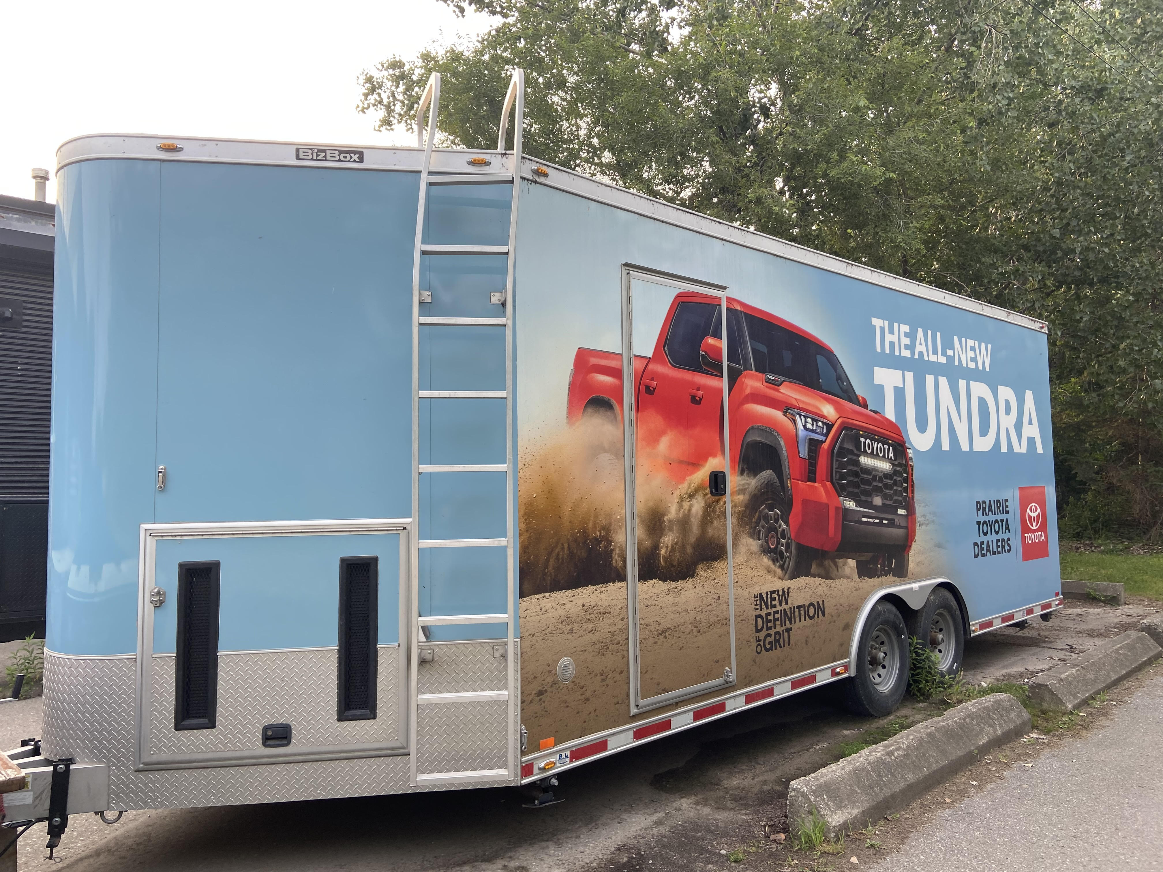 Light blue BizBox trailer marketing advertisement