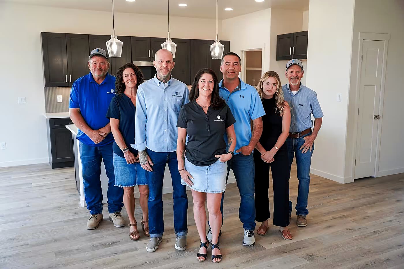 A home services team standing together in a finished kitchen.