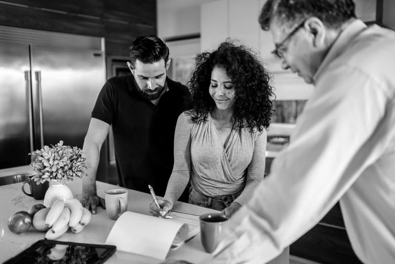 Rep walking homeowners through a quote at the kitchen table