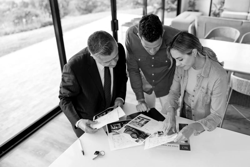 Builder sales team reviewing plans with buyers