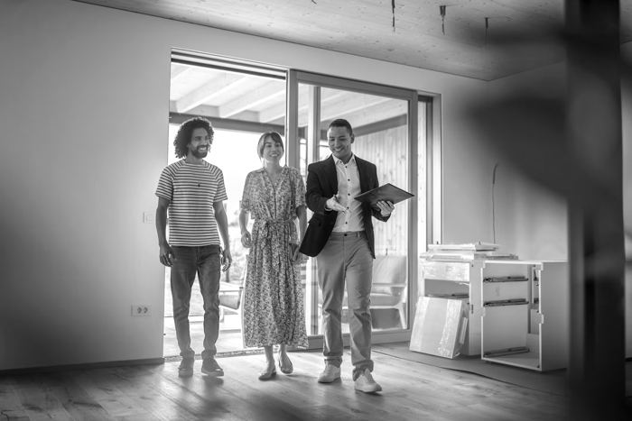 Sales rep walking homeowners through a new home