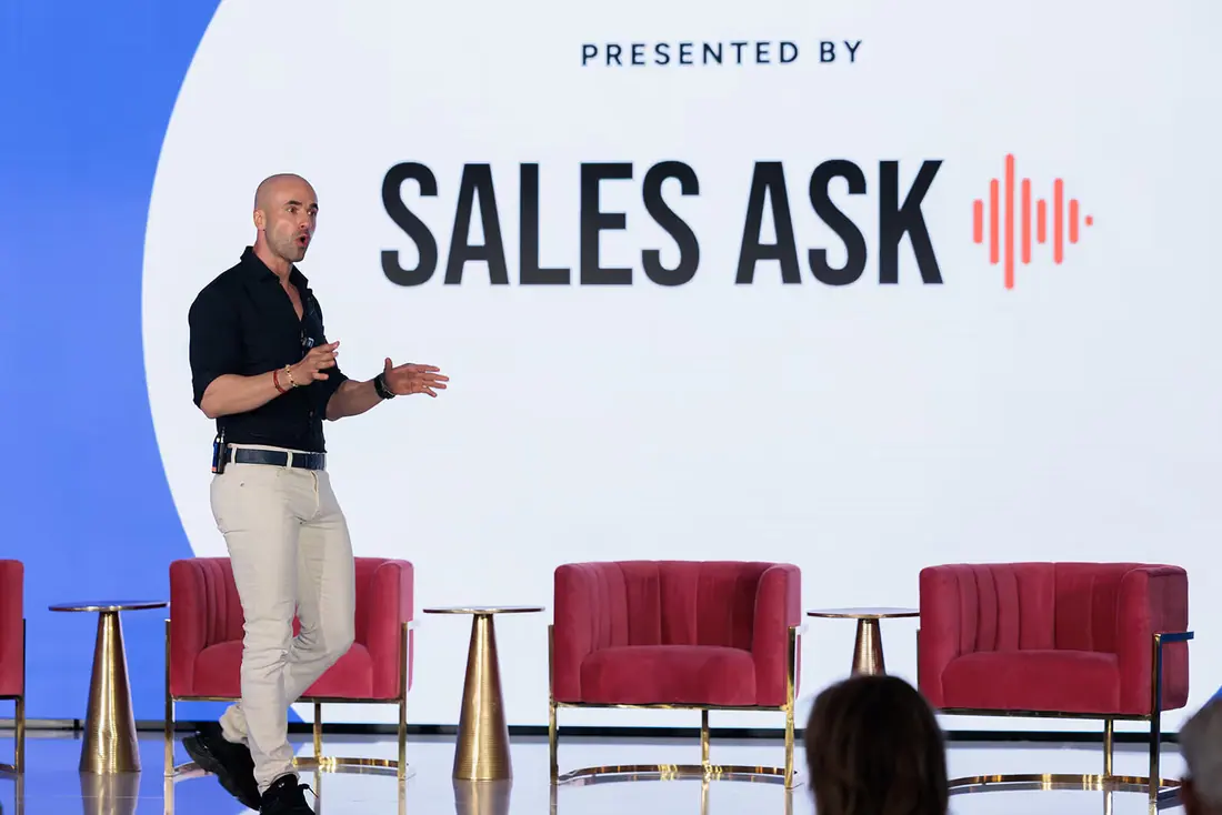 Moe Abbas speaking on stage at a SalesAsk event
