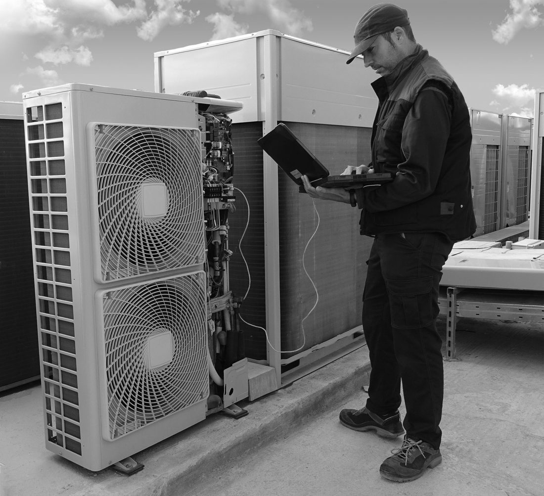 A Coolforce technician on a rooftop install