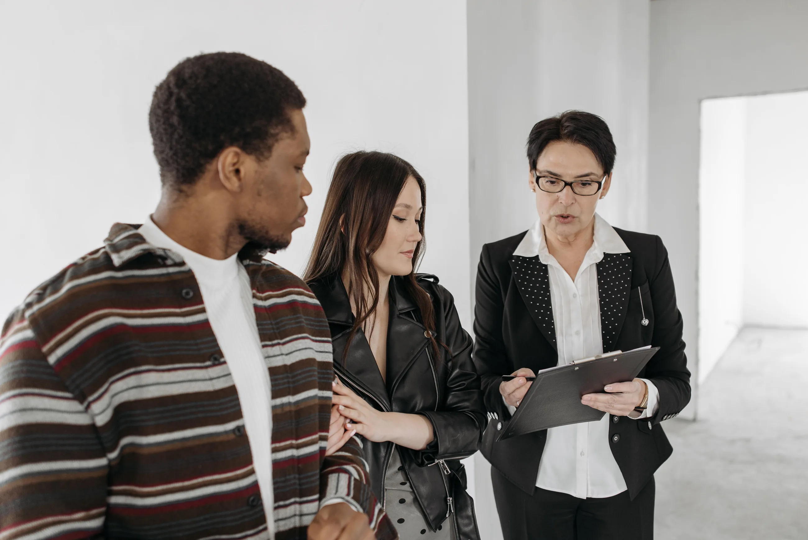 A rep going over a checklist with a couple during a home visit