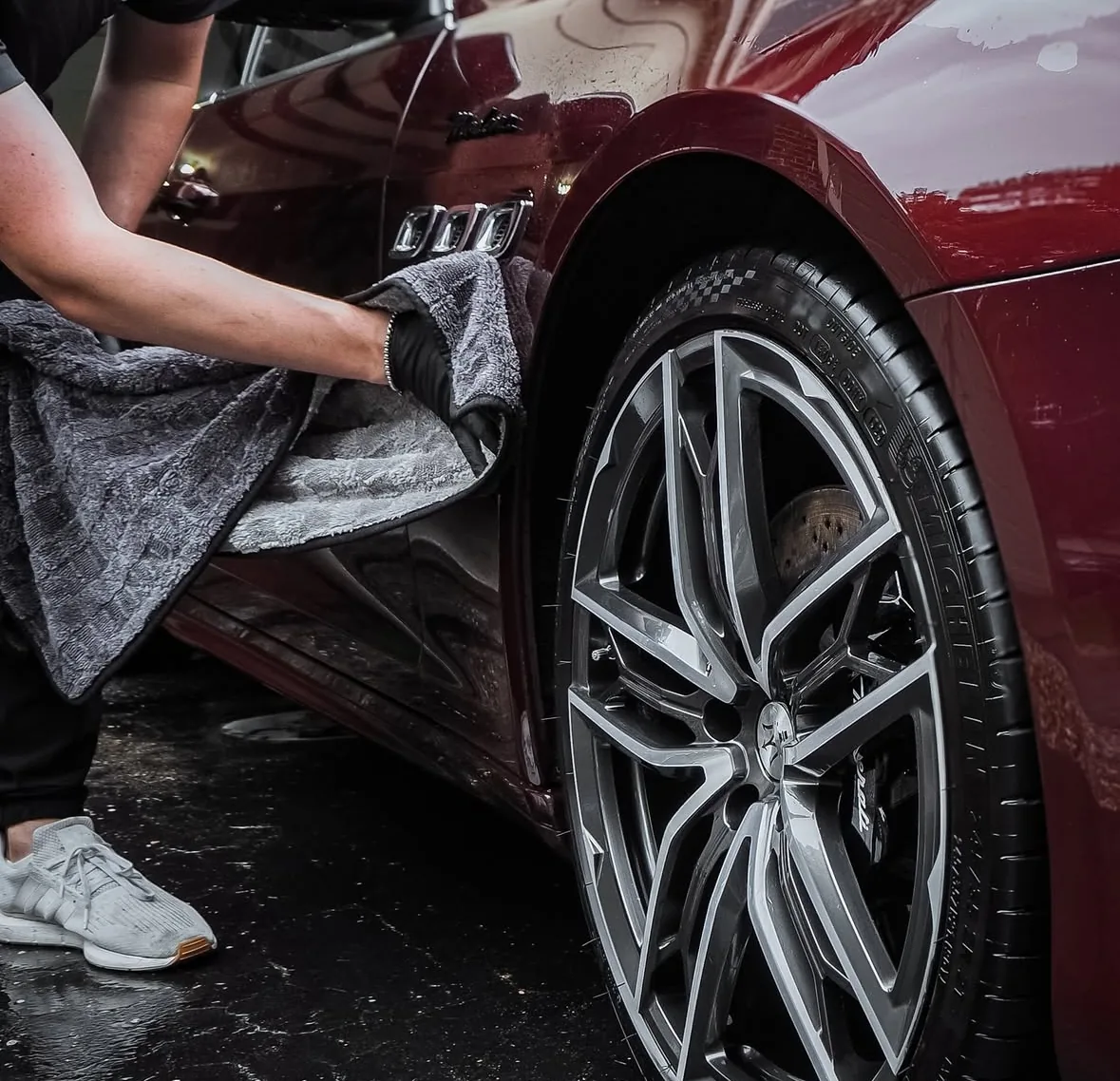 Maserati alloy wheel deep-cleaned to factory finish during a full premium auto detailing in Shakopee MN