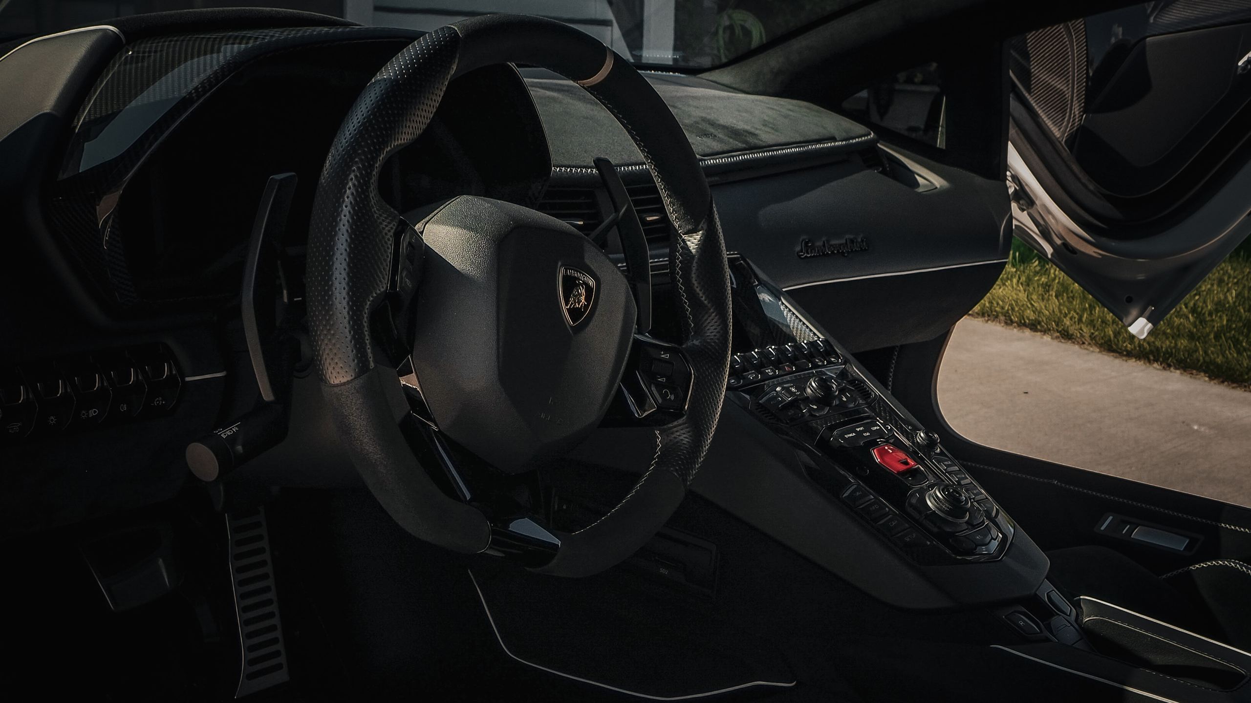 Lamborghini Aventador interior with carbon fiber dashboard, Alcantara stitching, and conditioned leather after a premium interior car detailing service by High Shine Detailing of Shakopee MN, serving Prior Lake, Savage, Burnsville, Eden Prairie, and the Twin Cities south metro