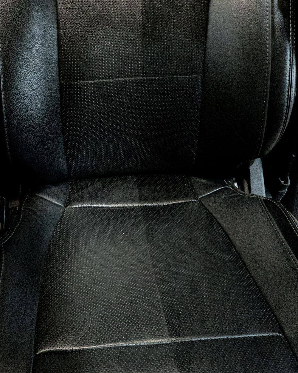 Black perforated leather car seat fully deep-cleaned and conditioned after professional interior detailing by High Shine Detailing of Shakopee MN