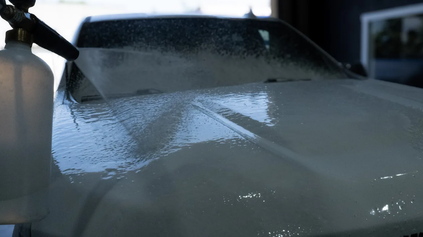 Foam cannon pre-soak melting away road grime as part of a hand-wash exterior car detailing service by High Shine Detailing in Shakopee MN, serving Eden Prairie and Edina drivers