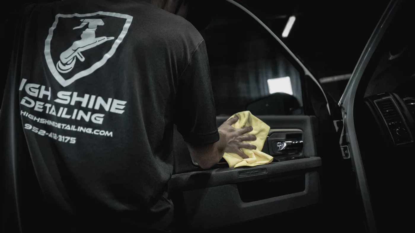 High Shine Detailing technician working inside a vehicle — interior car detailing service in Shakopee MN, serving Burnsville and Lakeville families