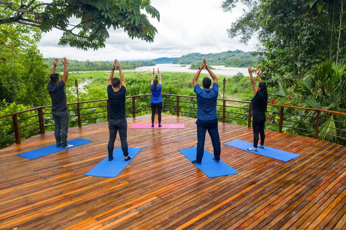 a group of people doing yoga on a deck
