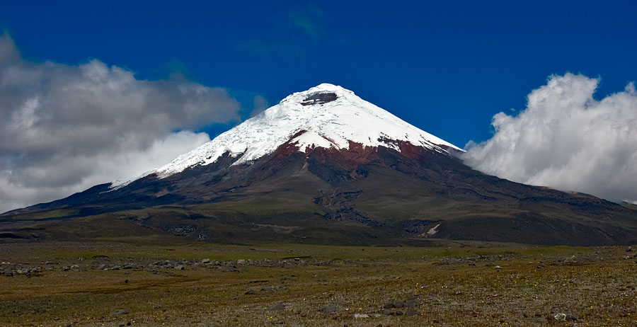 a large mountain with a snow capped peak