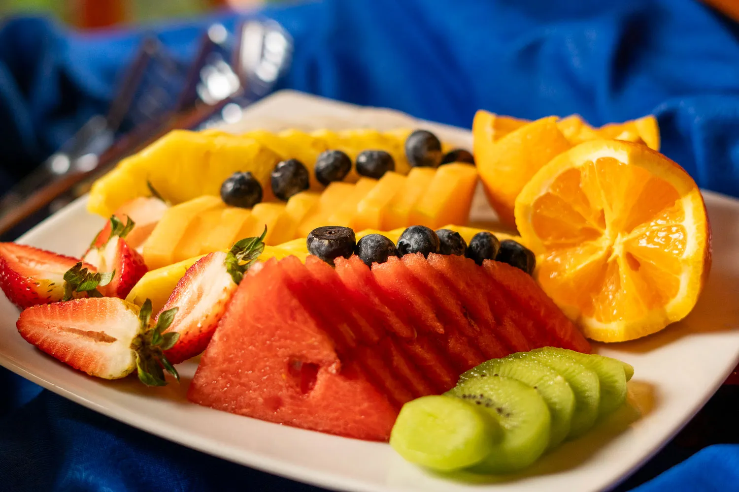 a white plate topped with sliced up fruit