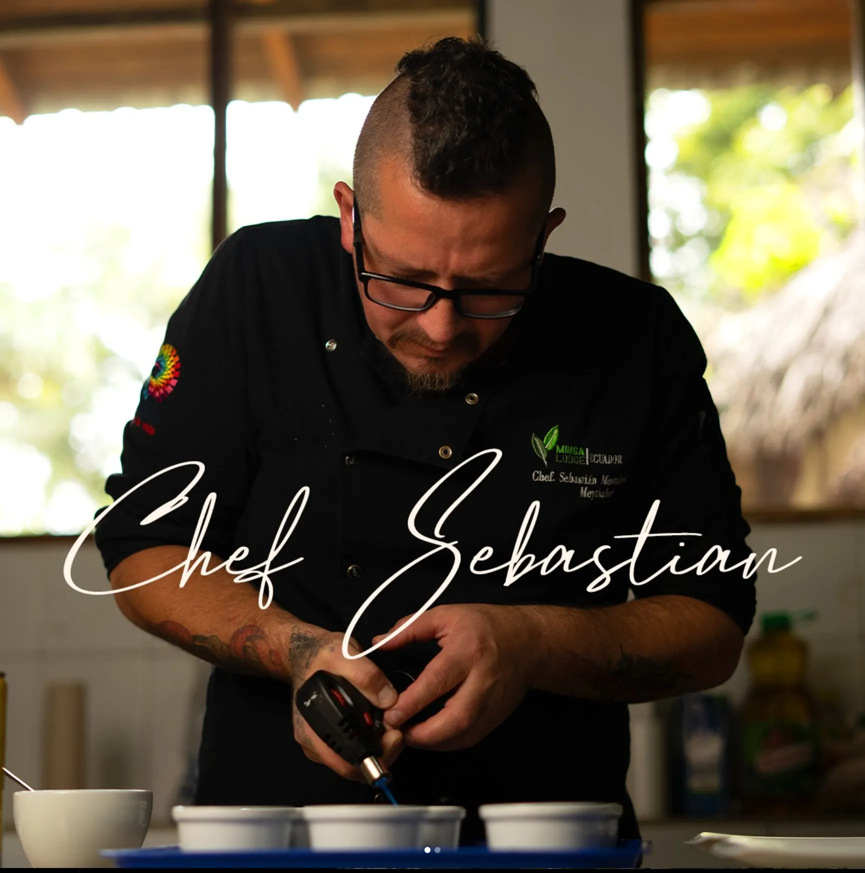 a man in a black shirt is pouring something into a cup