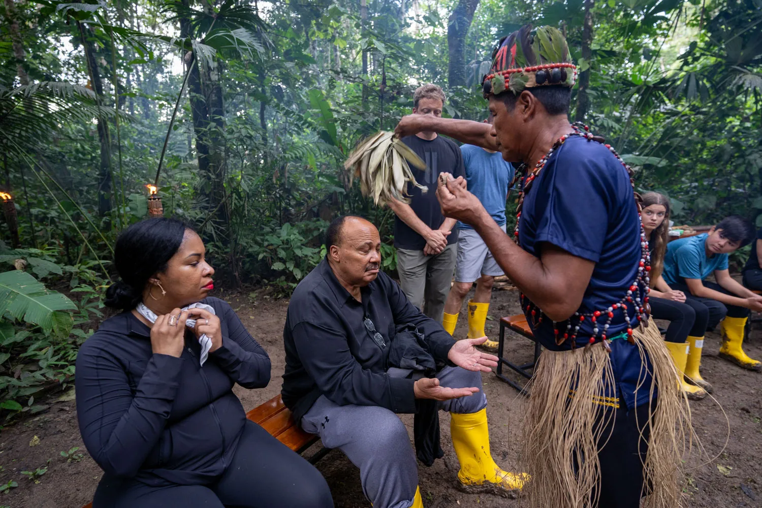 a group of people sitting on a bench in the amazon