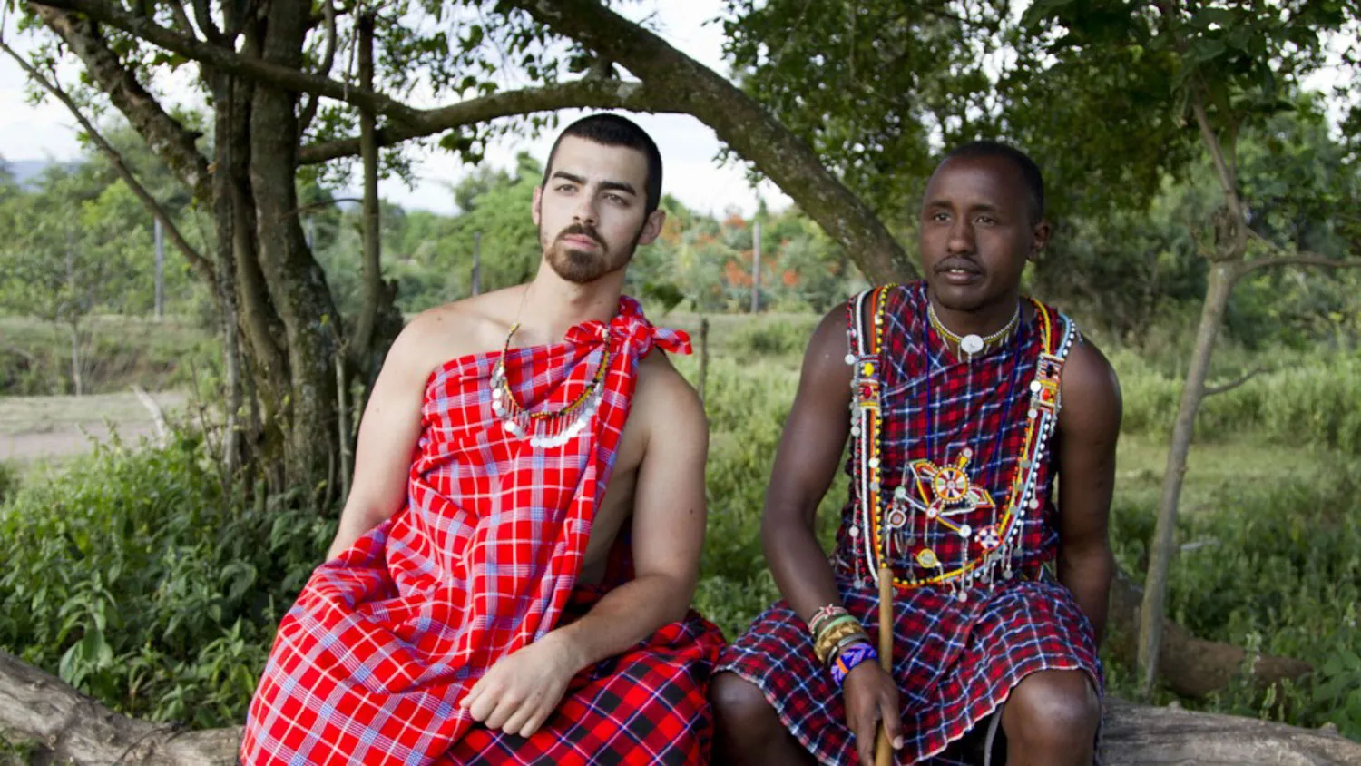 a couple of men sitting next to each other