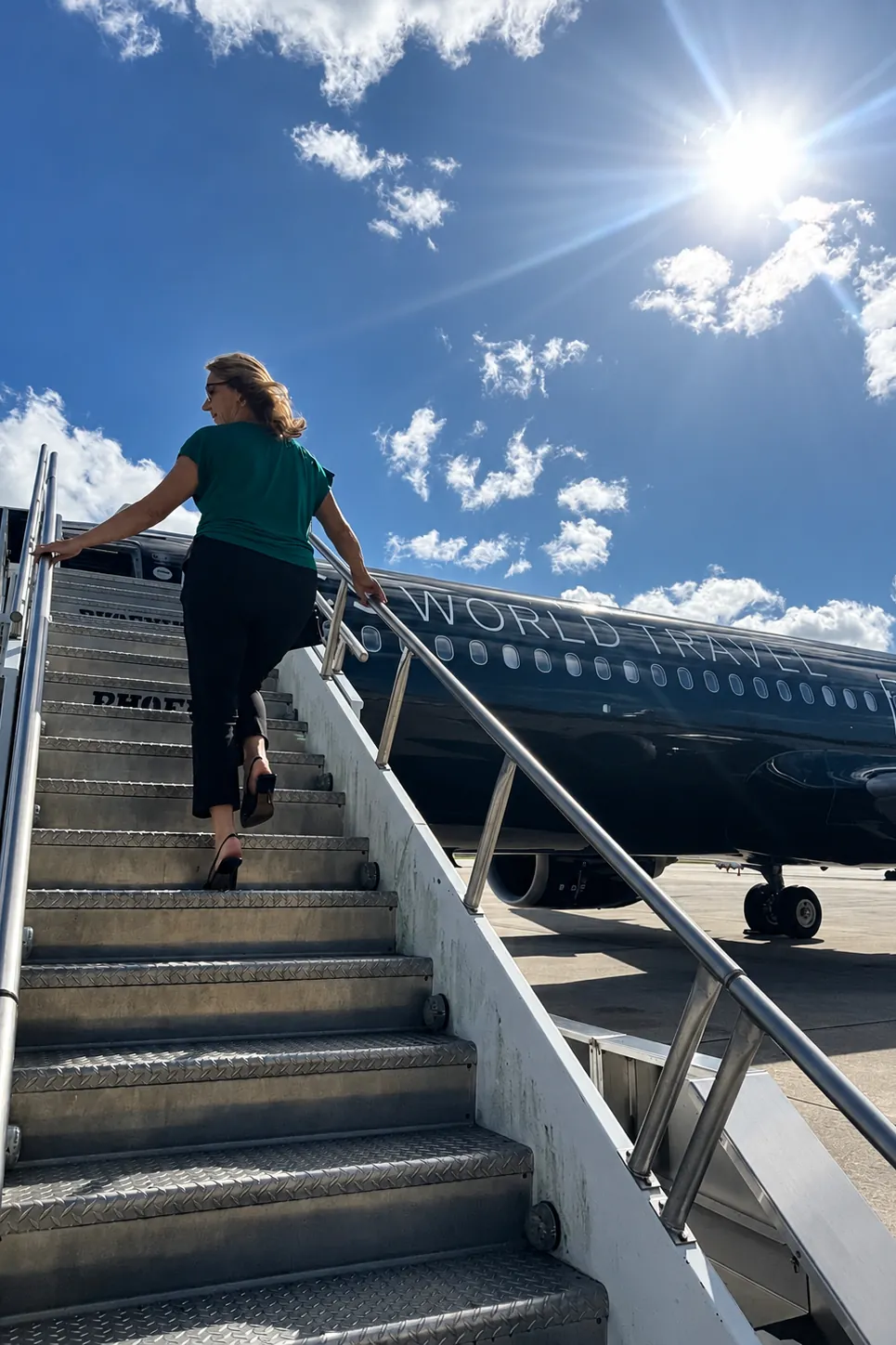 Tina Klump boarding a TCS World Travel private jet by airstair
