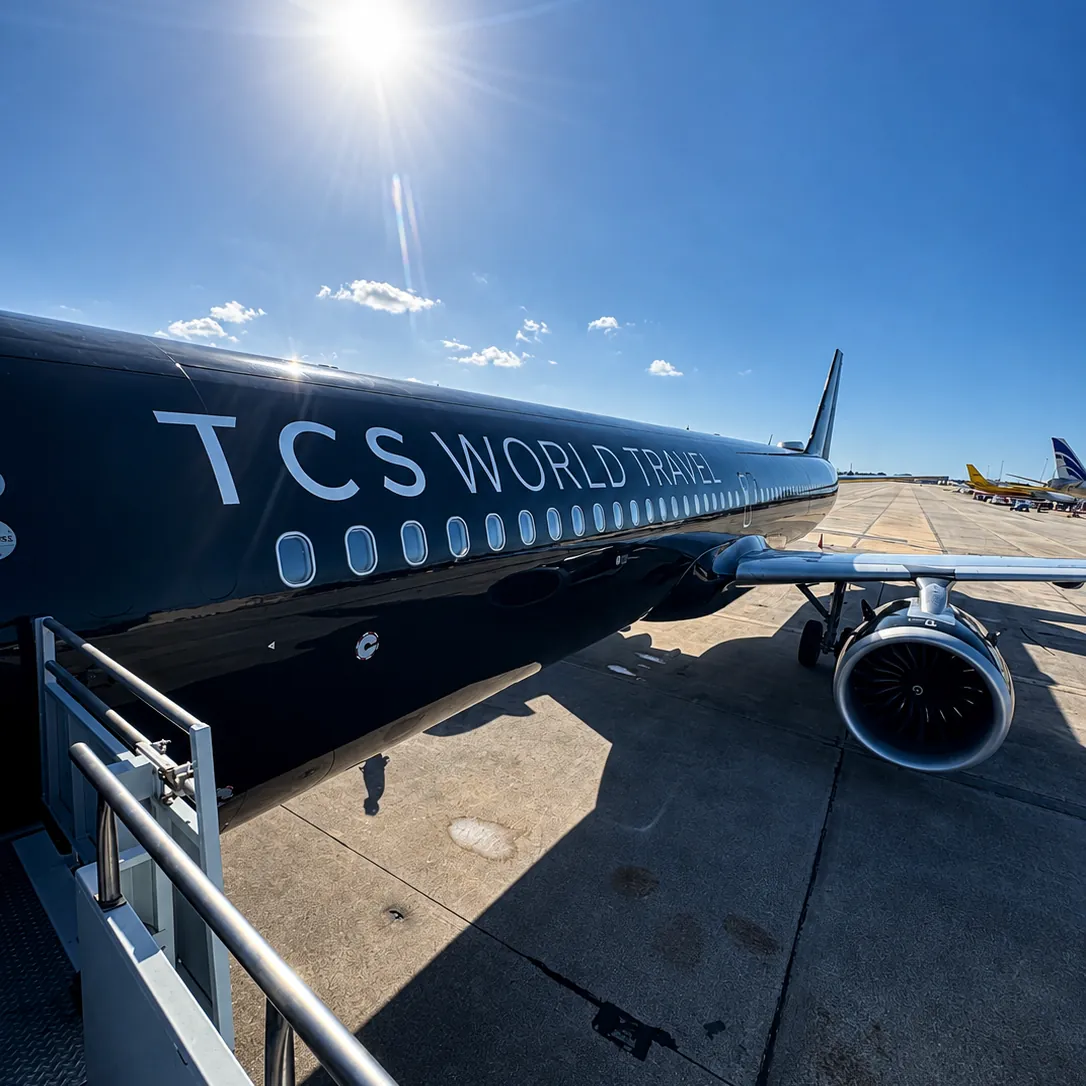 A TCS World Travel private jet on the tarmac