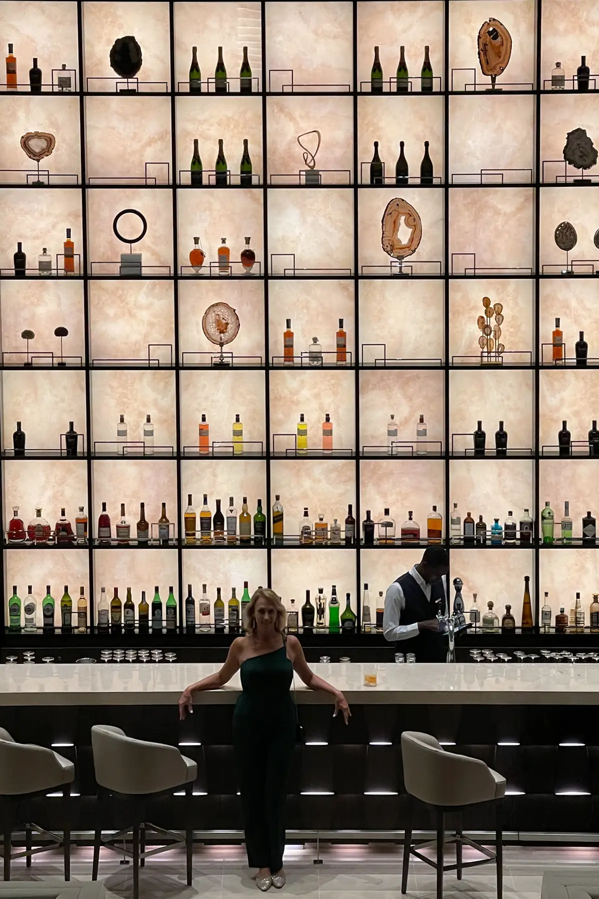 The backlit bottle wall in the bar aboard EXPLORA I