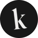 White lowercase letter 'k' centered on a black circular background.