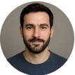 A man with a beard and a blue shirt.
