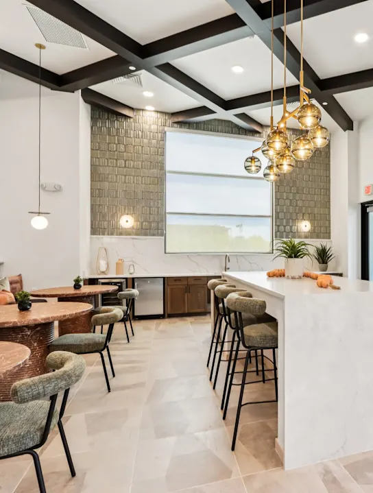 Clubhouse with kitchen featuring chairs and tables