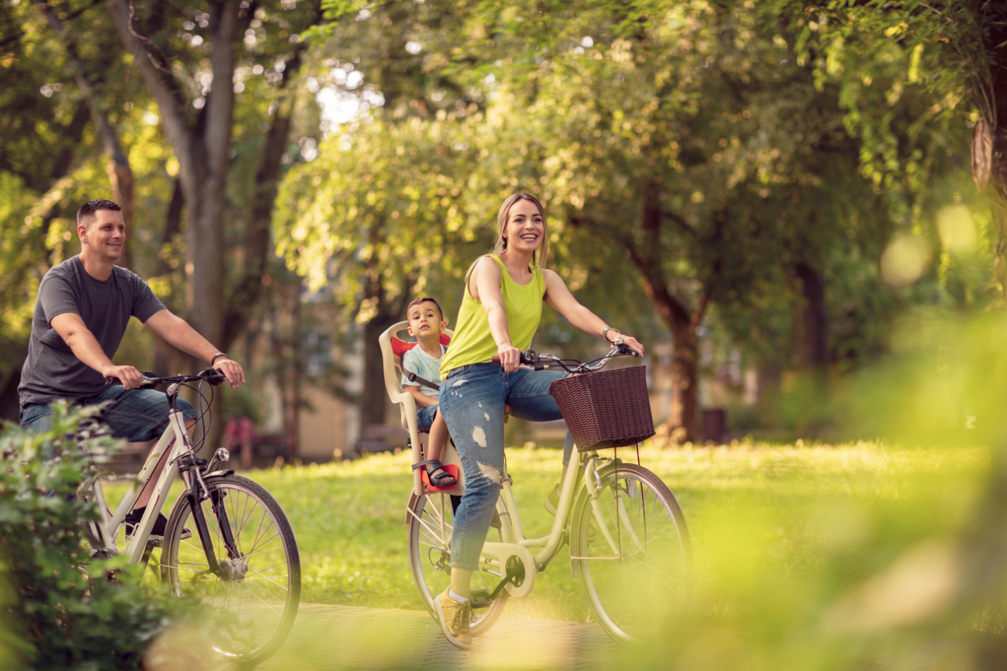 Family riding bikes in park stock image
