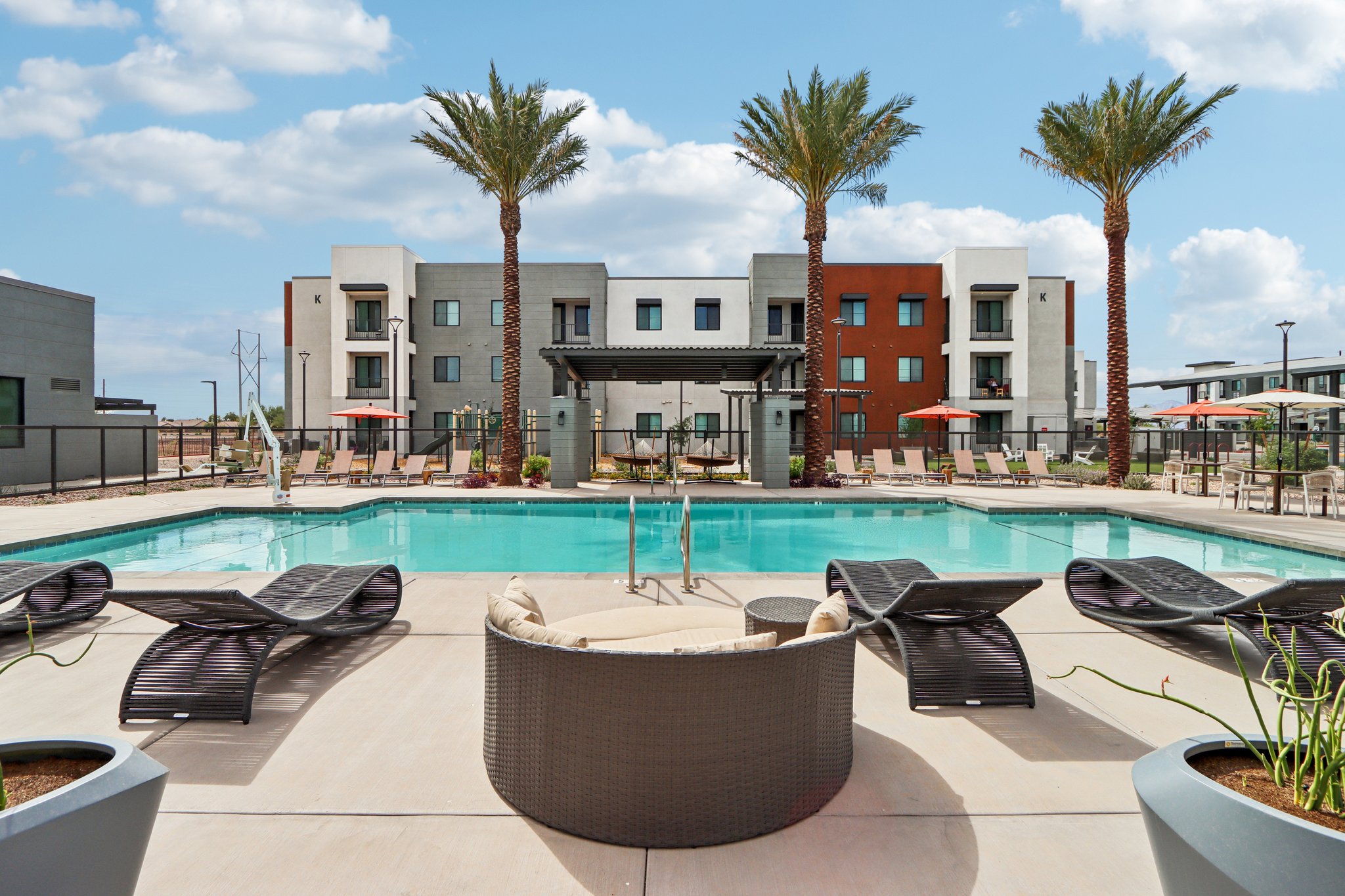 Swimming pool with lounge chairs, tables and umbrellas