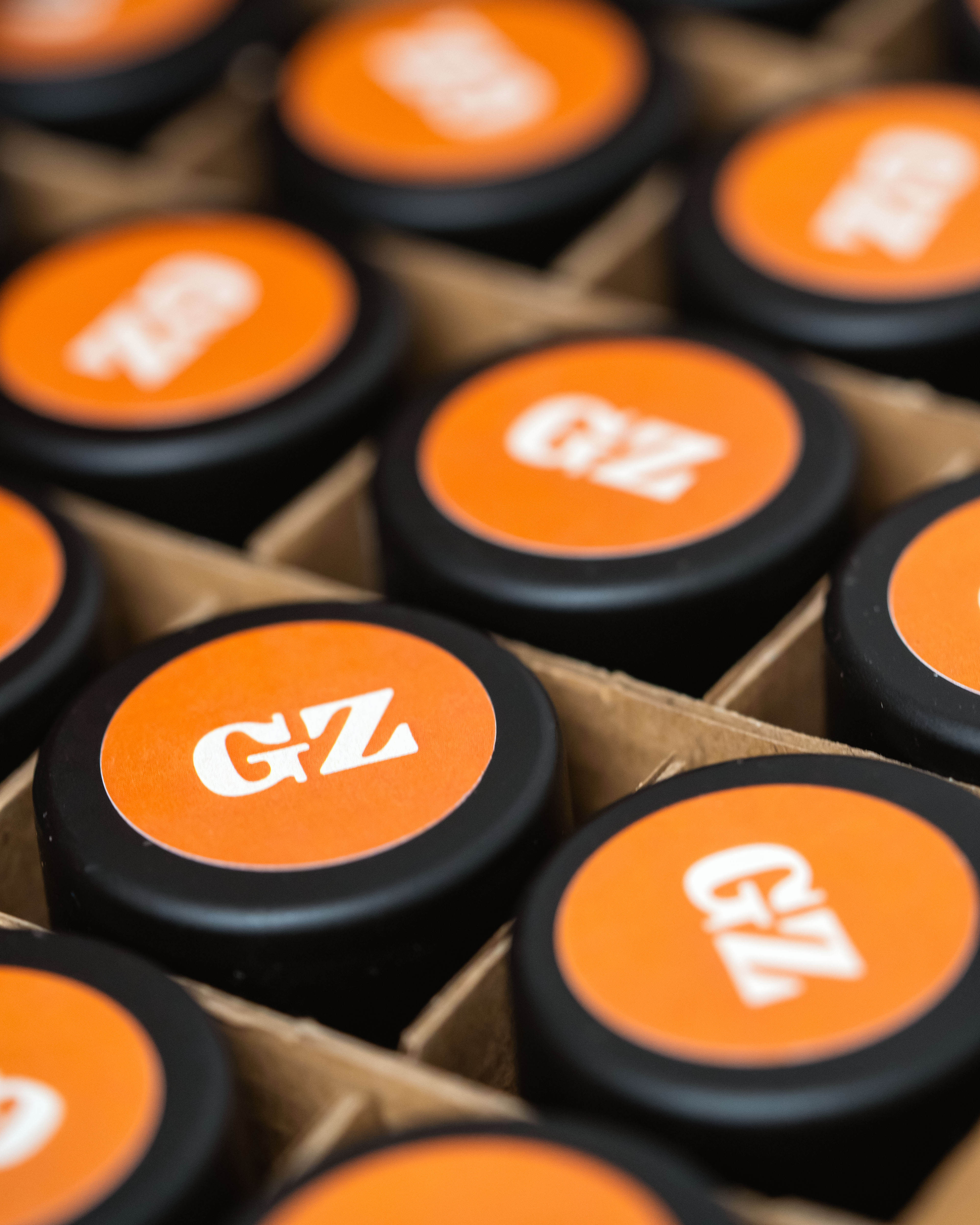 Grasslandz brand mini pre-roll jar tops. Orange with white GZ logo