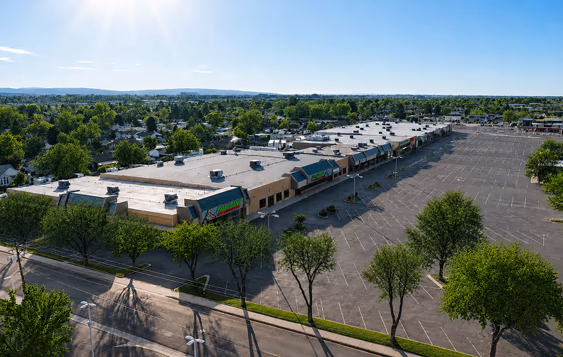 Aerial view of a shopping center and parking lot