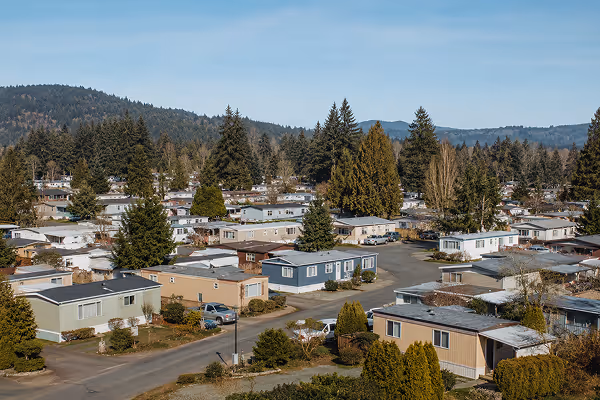 Aerial view of a mobile home park surrounded by trees