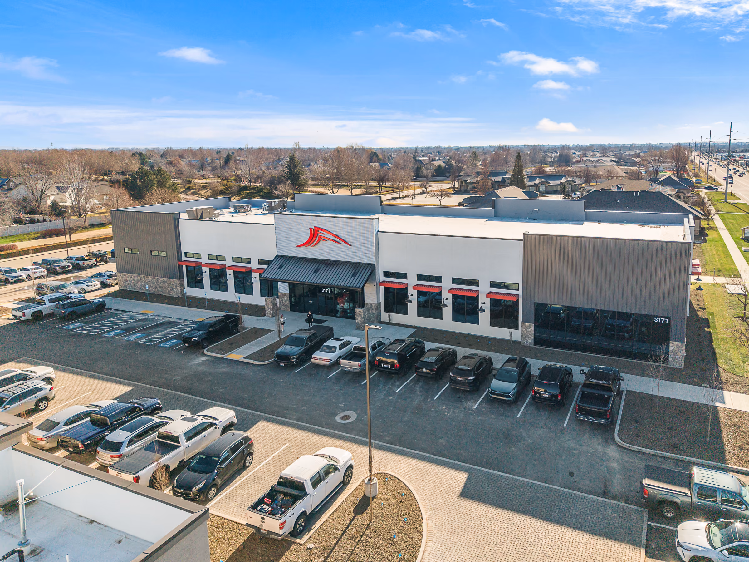 Aerial view of a retail building and parking lot