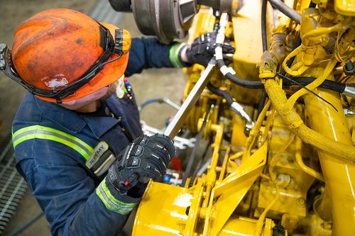 Mining heavy-duty maintenance mechanic working on a piece of equipment