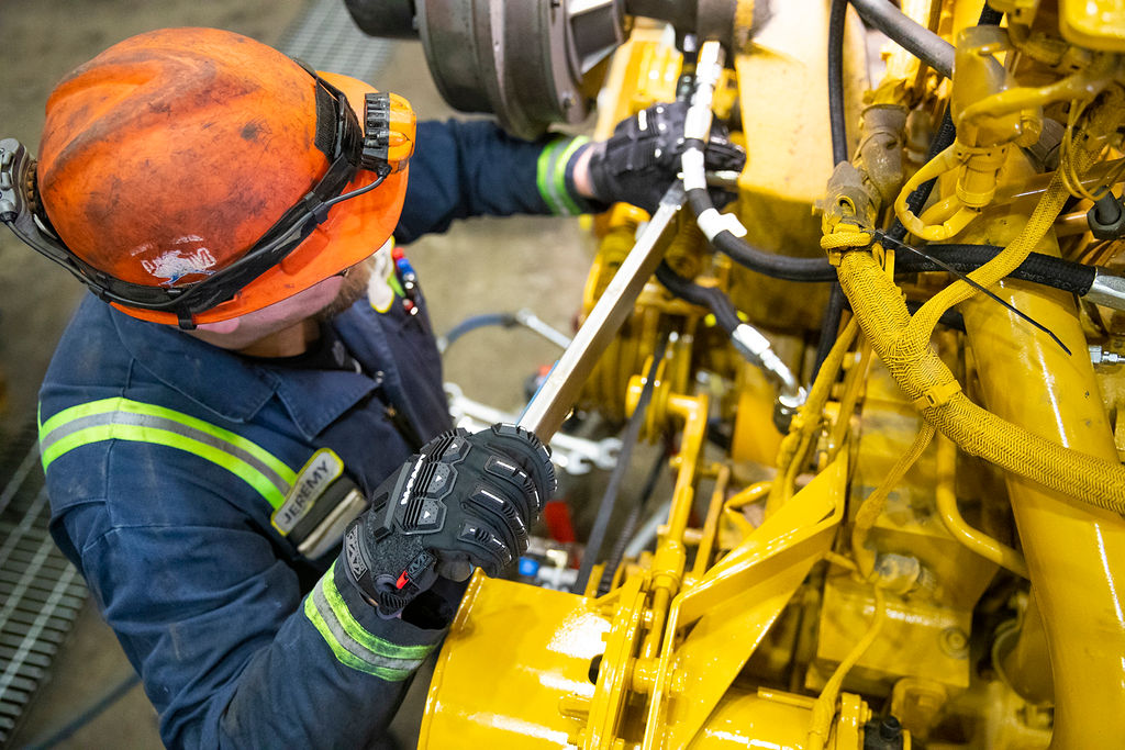Mining heavy-duty maintenance mechanic working on a piece of equipment