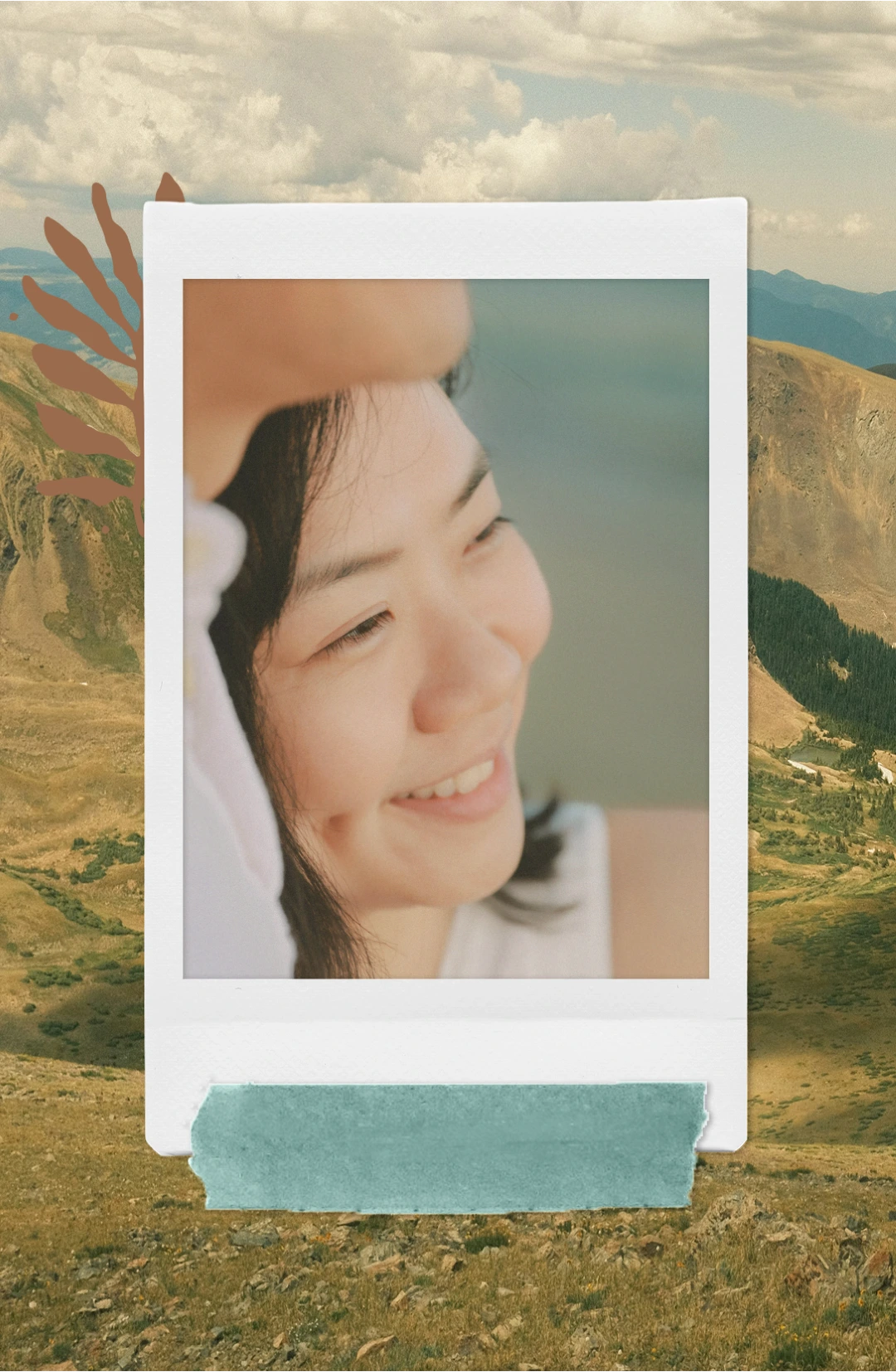 Close-up of a smiling woman with dimples in a framed Polaroid-style photo over a mountainous landscape background.