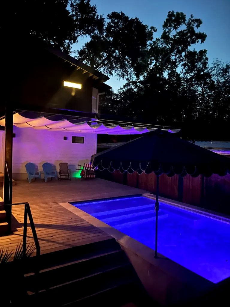 The canopy catching blue light from the pool after dark