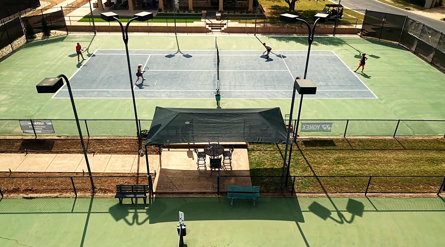 Aerial view of Lakecliff Racquet Club courts with the recovered freestanding shade structure courtside