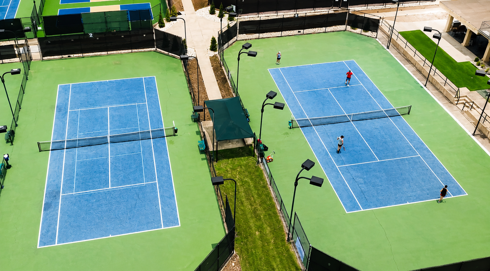 Aerial view of Lakecliff Racquet Club courts with players and recovered shade structure