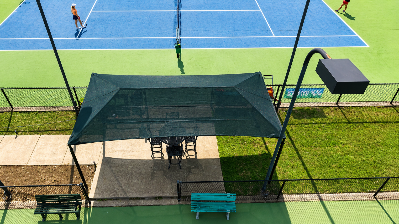Recovered freestanding shade structure courtside at Lakecliff Racquet Club