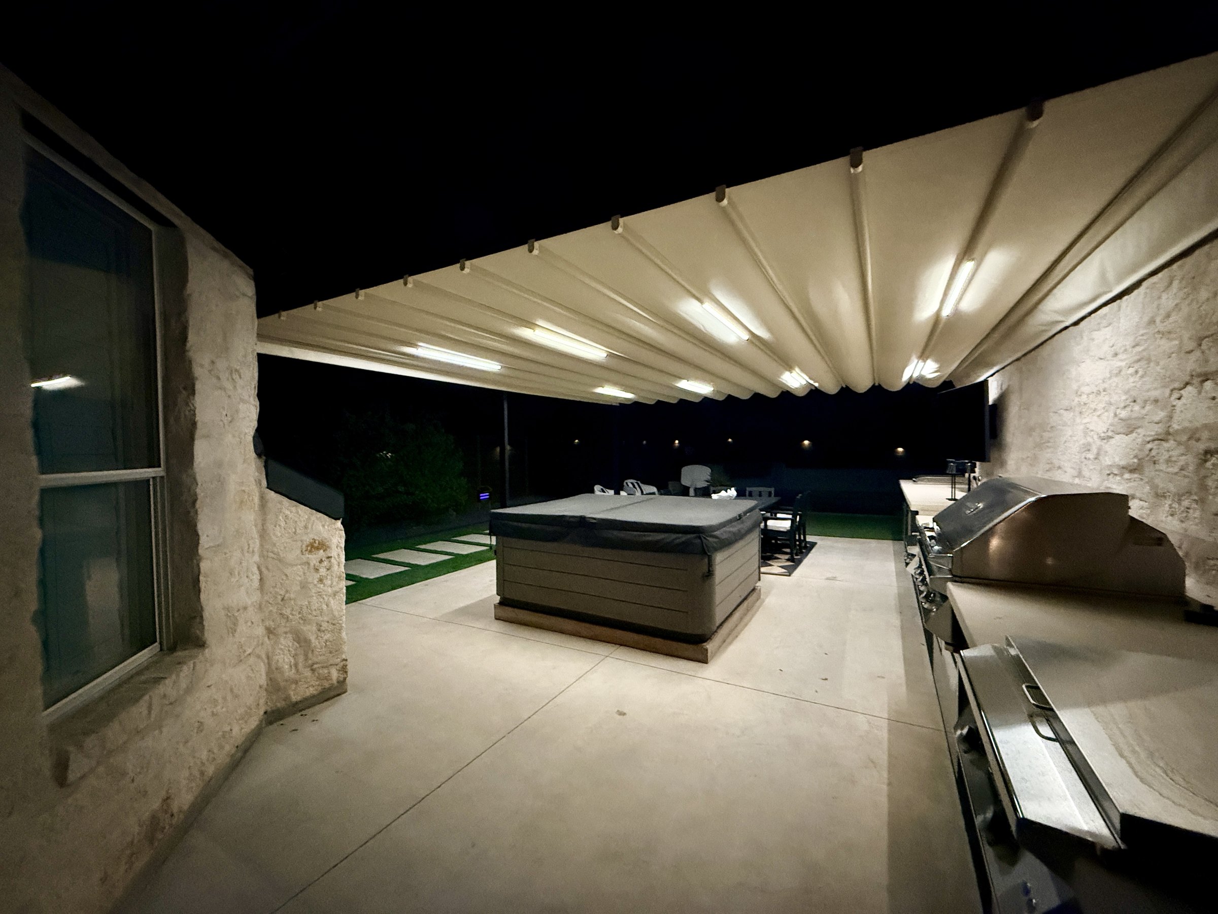 The Lakeway Outdoor Room at night, lit from the canopy