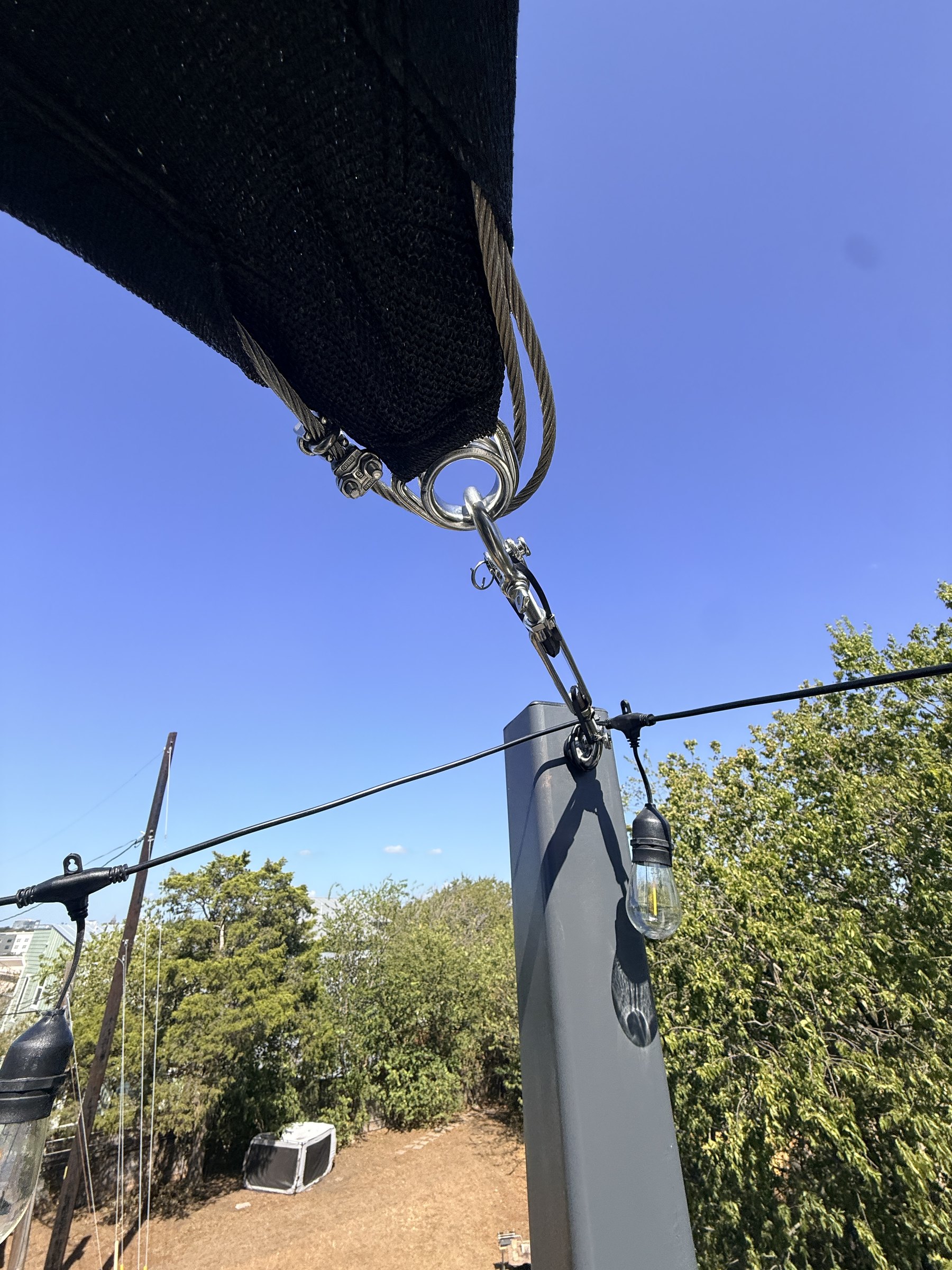 Sail corner shackled to a steel post at the rooftop parapet
