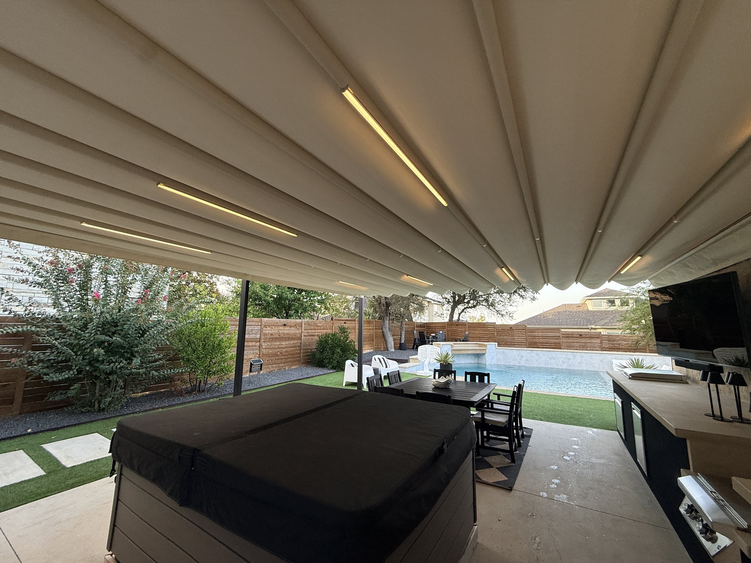 Under the Palladia canopy looking out to the pool, with the canopy lights on