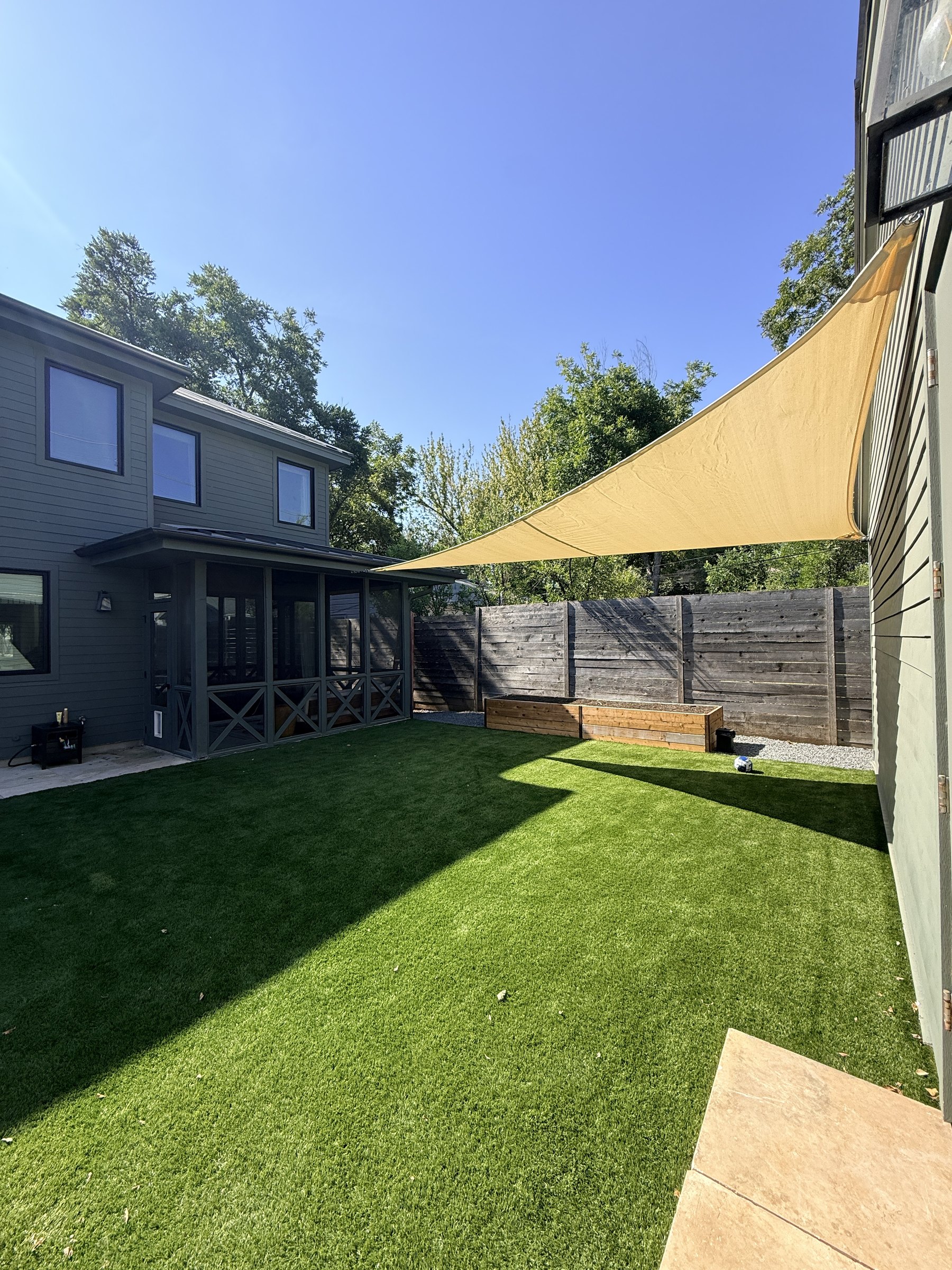 Triangle sail anchored between the garage and the house eave