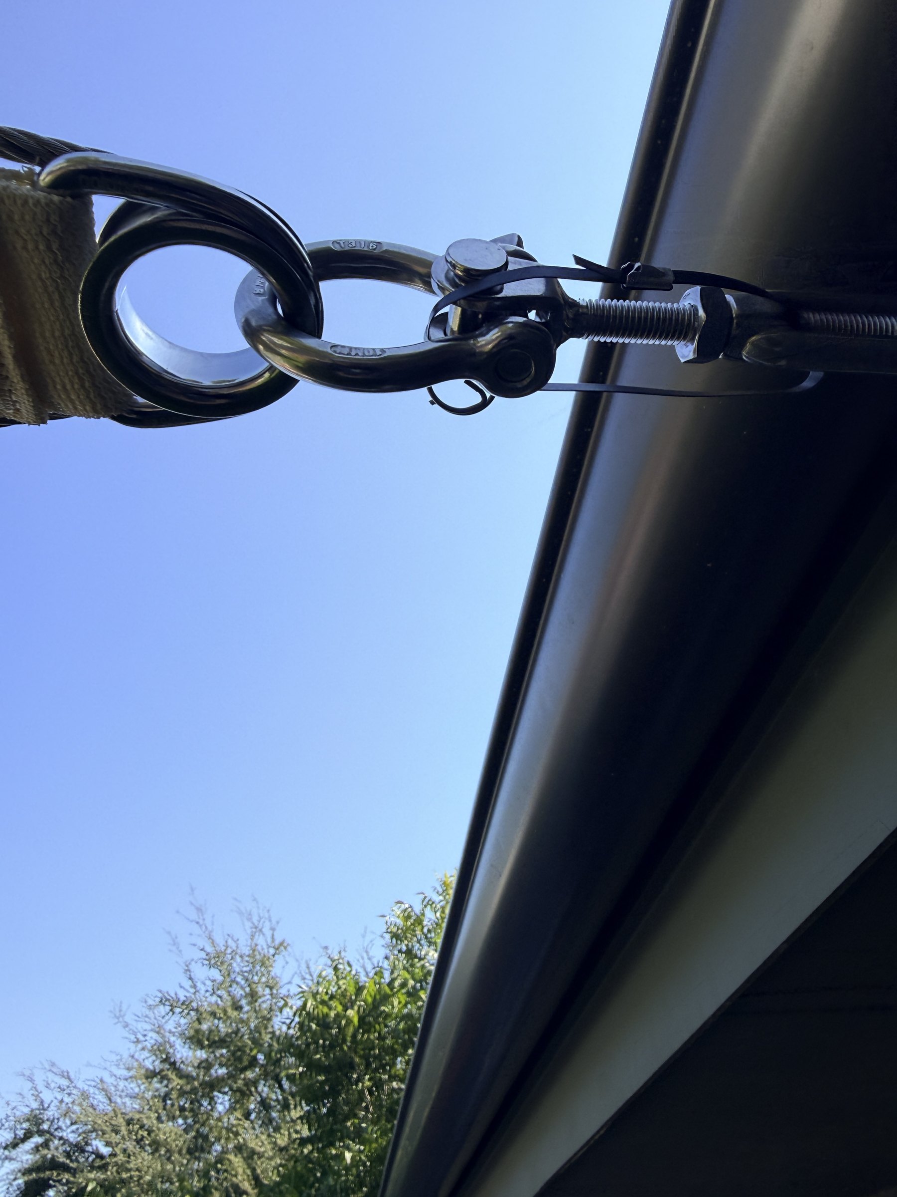Close-up of the stainless hardware and turnbuckle at the sail's house corner