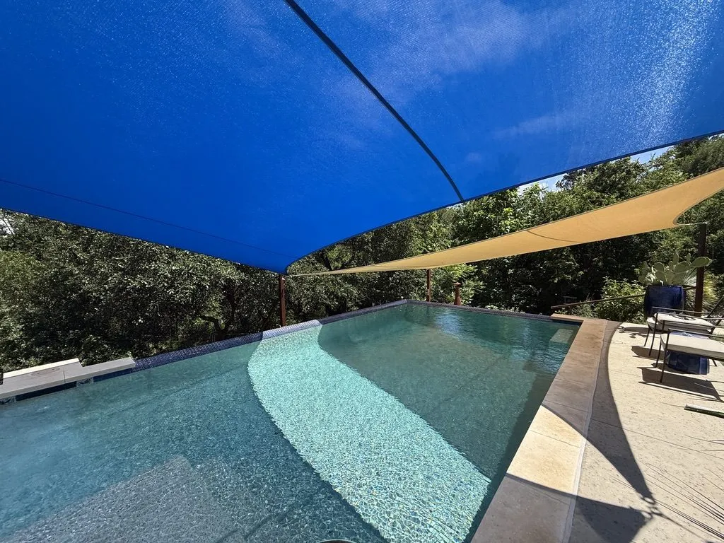 Looking up from the pool deck under the blue sail, with the sand sail beyond